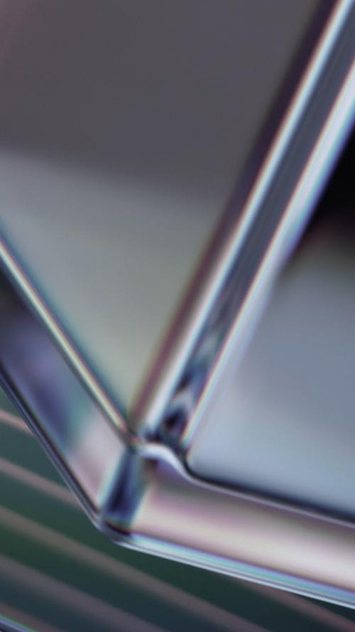 Close up of glass shapes spinning against a black background